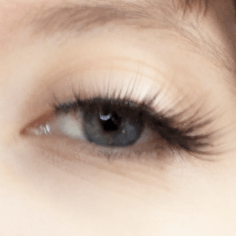 Long, curled lashes on a model's eye.